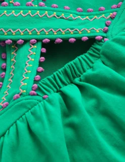 Top à dos croisé détail pompons